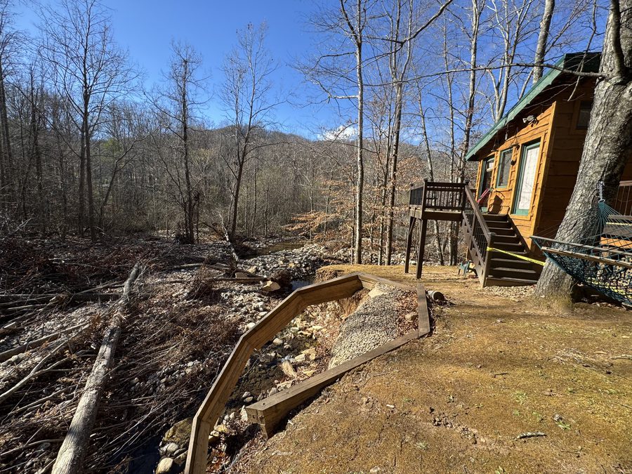 Handcrafted creekside fire pit with boulder walls